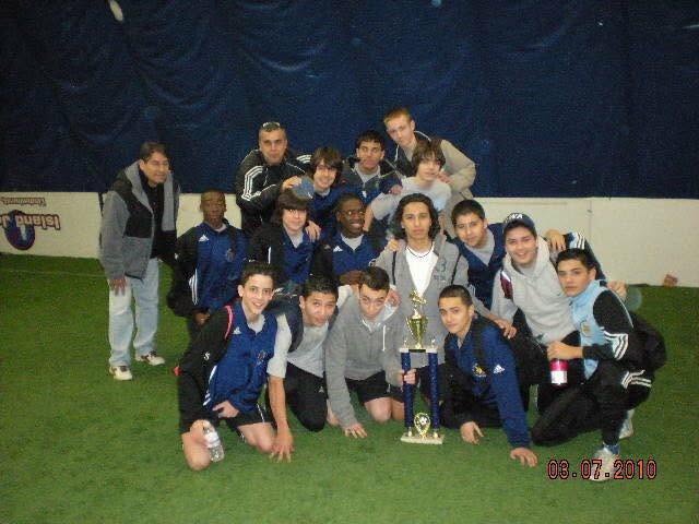 Youth soccer team gathered around a trophy in a 2010 photo